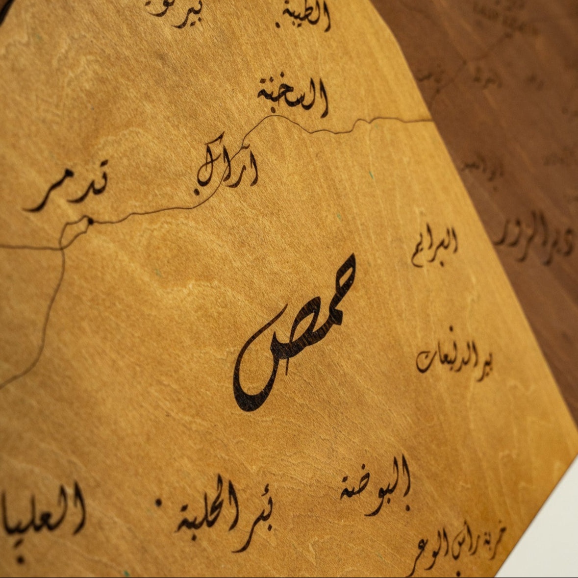 Close-up of syria 3D Wooden map with Arabic text on brown paper