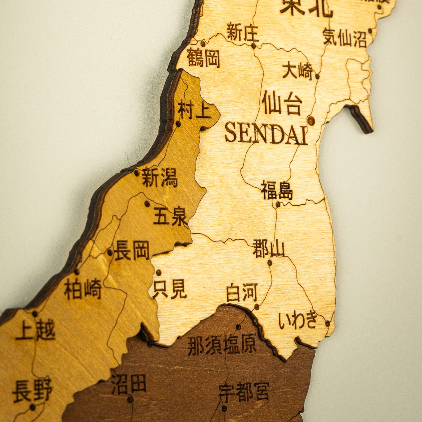 Wooden map of northeastern Japan with cities labeled