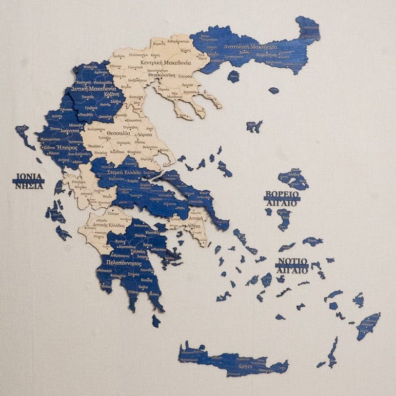 Wall decal of a map of Greece on a plain wall above a beige sofa.