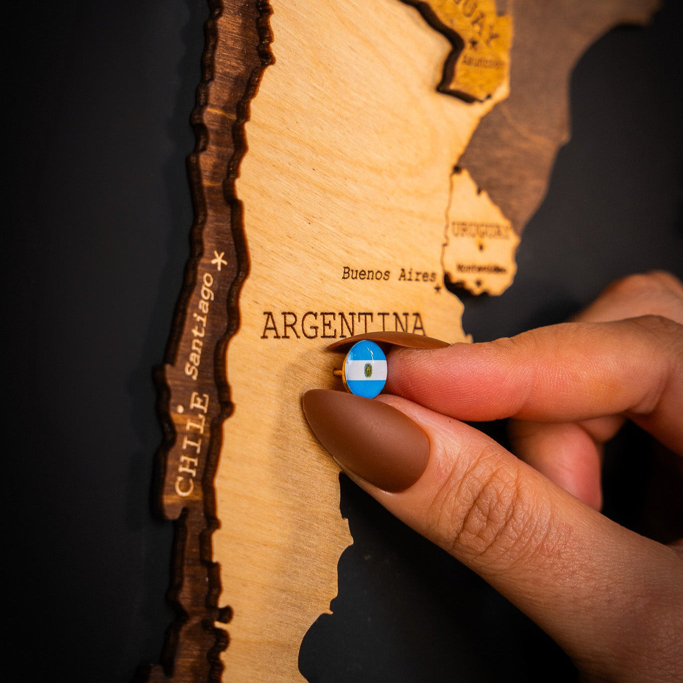 person using travel map flag push pins