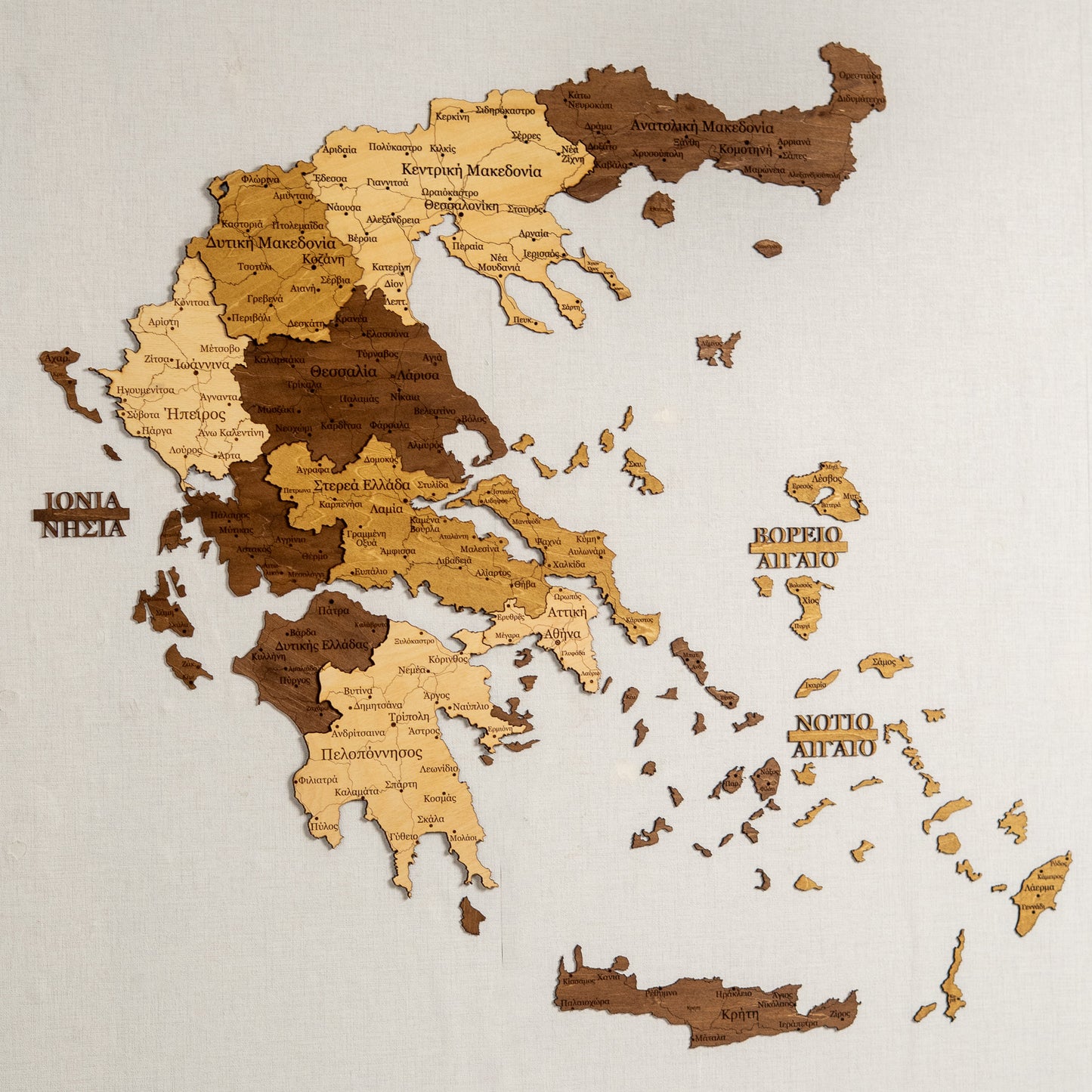 3D Wooden map of Greece with regions labeled on a beige background