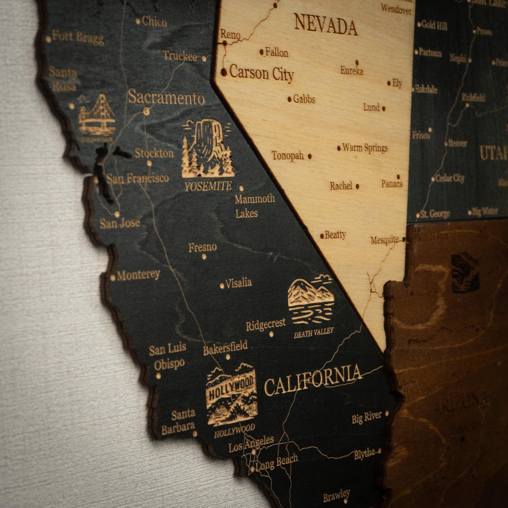 Wooden map of California and Nevada with illustrations and text.
