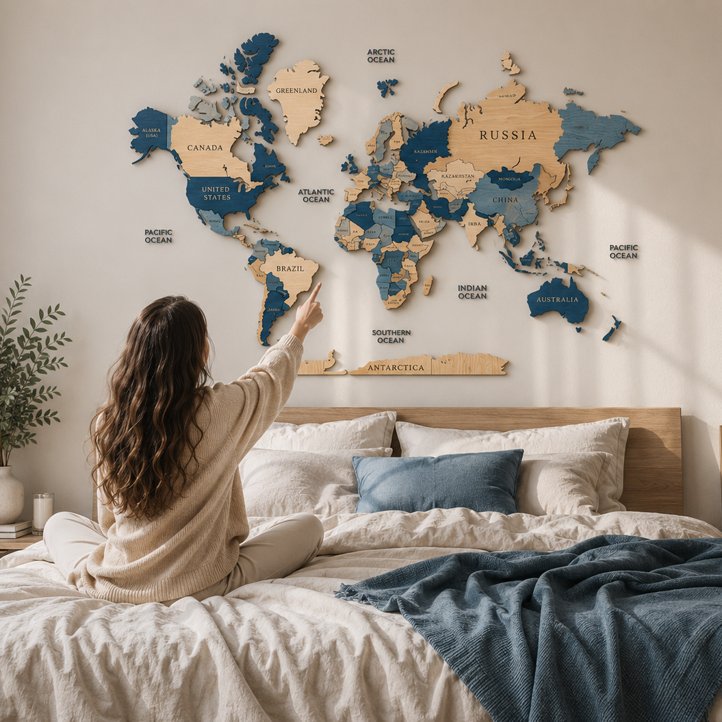 Woman sitting on a bed with a world map on the wall above her.