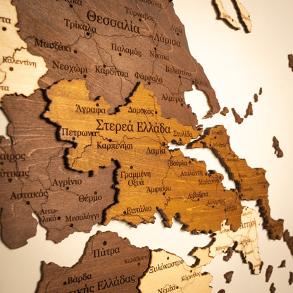 Wooden map of Greece with Greek text on a beige background