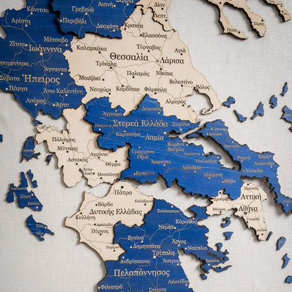 Wooden map of Greece with Greek text on a white background