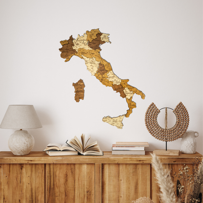 Wooden map of Italy on a white wall above a wooden cabinet with books and decor.