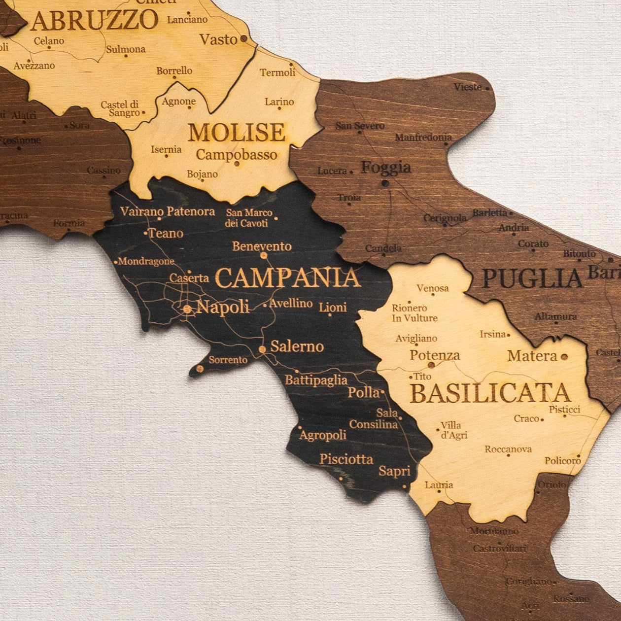 Wooden map of Italy with regions labeled on a light gray background