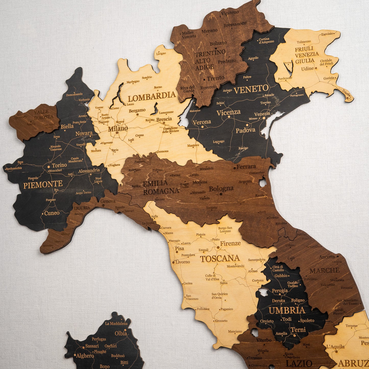 Wooden map of Italy with regions labeled on a white background