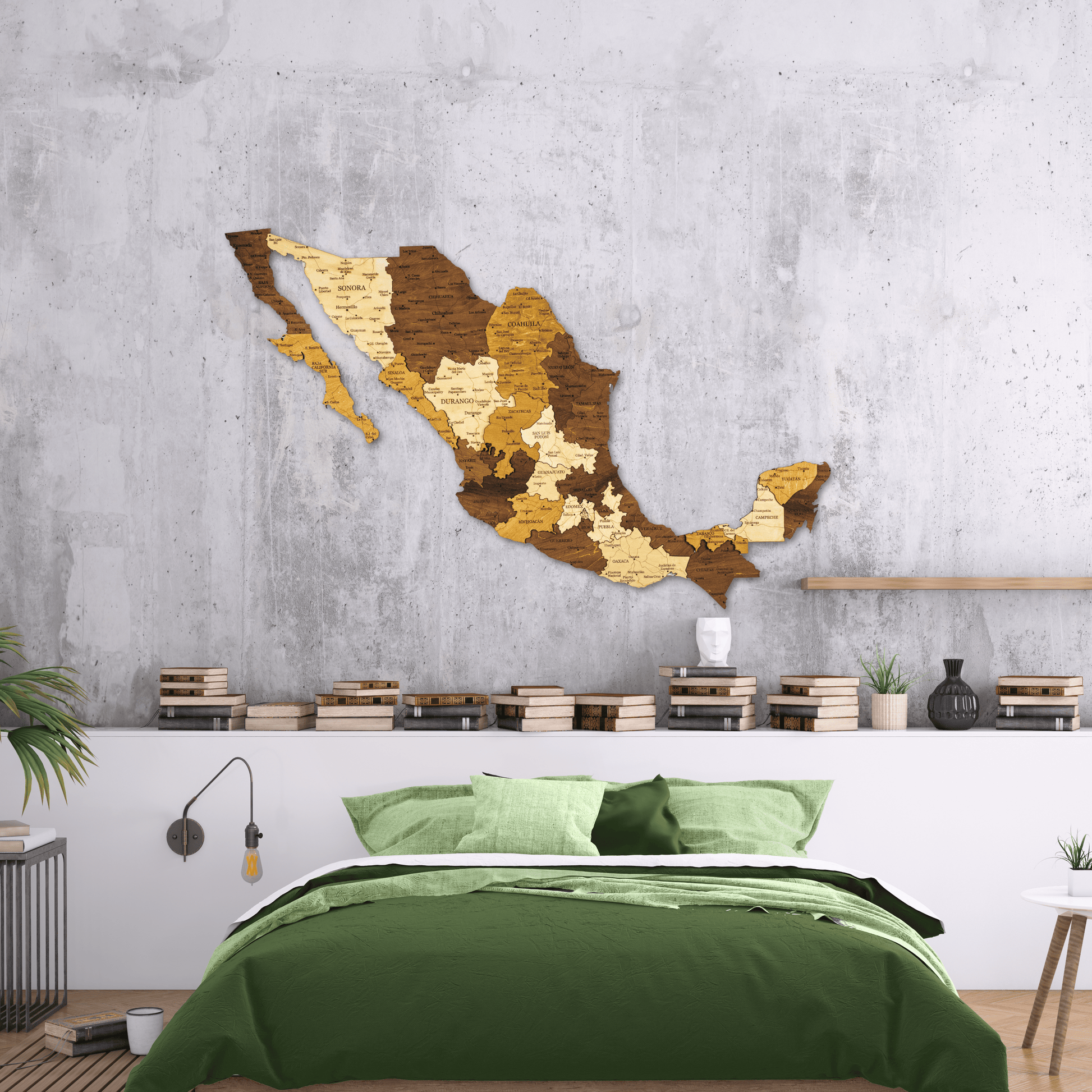 Wooden wall art of a map of Mexico in a bedroom with green bedding and a concrete wall.