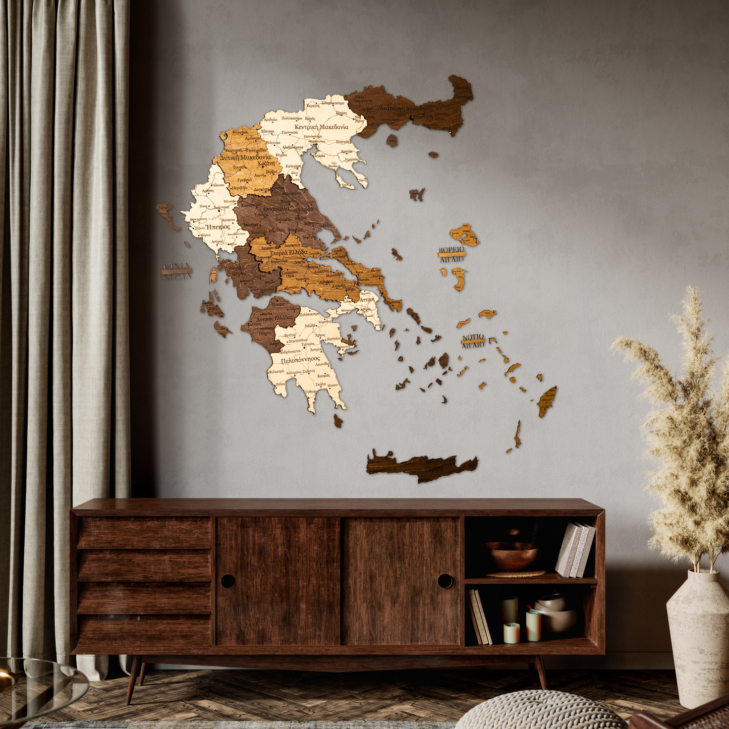 Wooden wall map of Greece on a gray wall above a wooden cabinet.