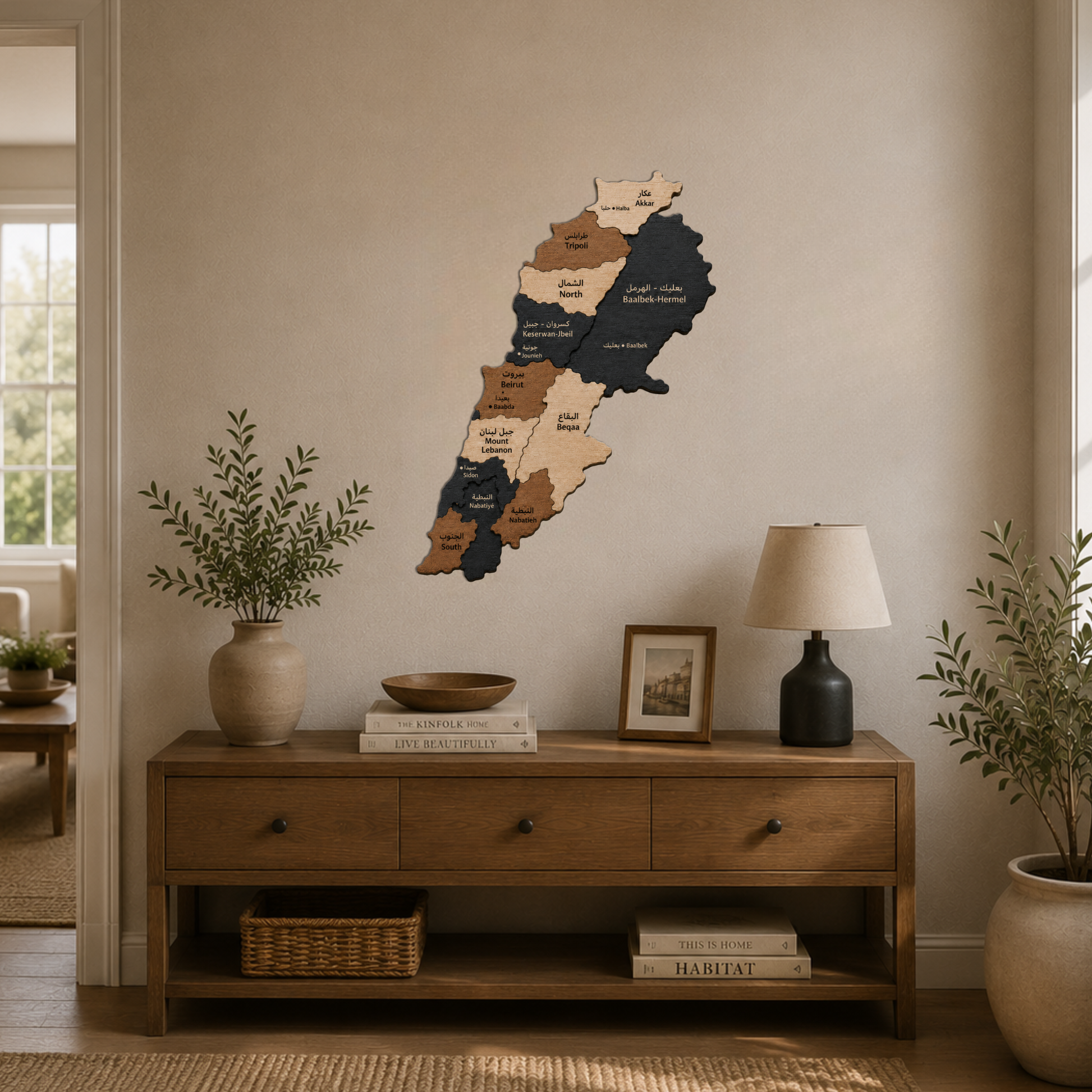 Wooden wall map of lebanon on a neutral wall above a wooden console table with decor items.